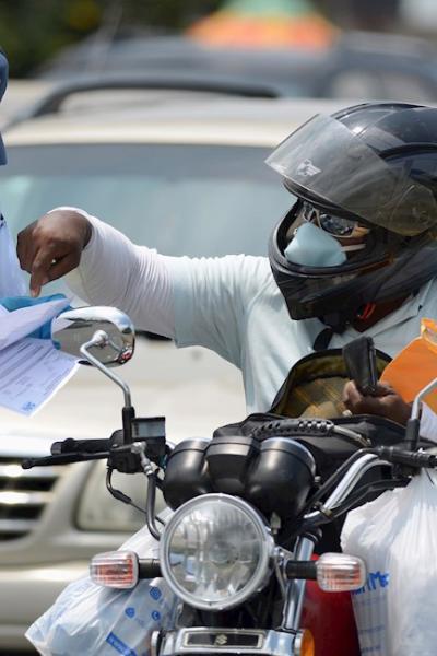 Un agente de tránsito revisa salvoconductos en el puente de la Unidad Nacional, en Guayaquil, el 23 de abril de 2020.