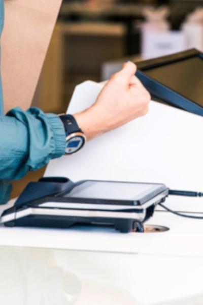 Una mujer paga en un local comercial con un reloj inteligente en 2020.