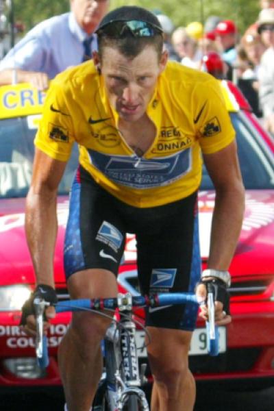 US Postal team rider Lance Armstrong of the USA is cheers by supporters as he climbs to La plagne du..