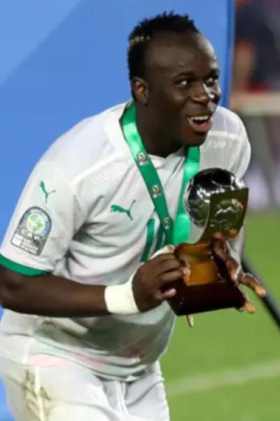 El jugador de Senegal, Samba Diallo, festeja con un trofeo.