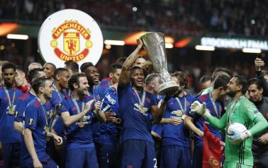 Manchester United's Antonio Valencia and team mates celebrate winning the Europa League with the trophy