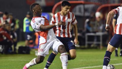 Luis Advíncula y Diego Gómez disputan un balón durante el partido de las Eliminatorias entre Paraguay y Perú, el 7 de septiembre de 2023.