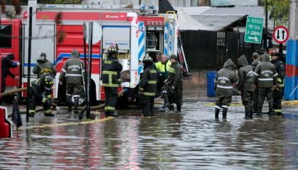 Carabineros y bomberos trabajan en calles inundadas por la lluvia en Santiago de Chile, el 13 de junio de 2024.