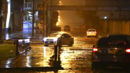 Vehículos transitando por una calle inundada en Lima, Perú, el 17 de agosto de 2026.