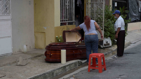 Una mujer mira el ataúd de su madre, que presuntamente falleció por coronavirus en Guayaquil el 31 de marzo de 2020.