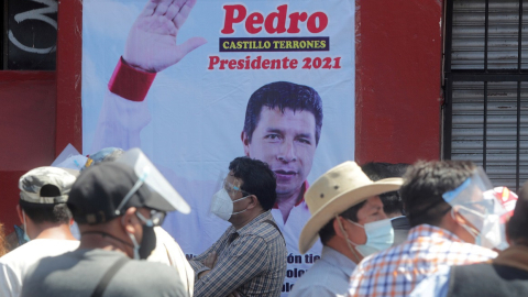 Simpatizantes del candidato socialista de Perú, Pedro Castillo, junto a un afiche del presidenciable, el 22 de abril de 2021.