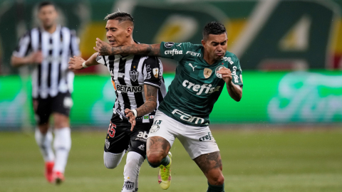 Eduardo Pereira (d) de Palmeiras disputa un balón con Matías Zaracho de Mineiro, en la semifinal de ida de la Copa, el 21 de septiembre de 2021, en Brasil.