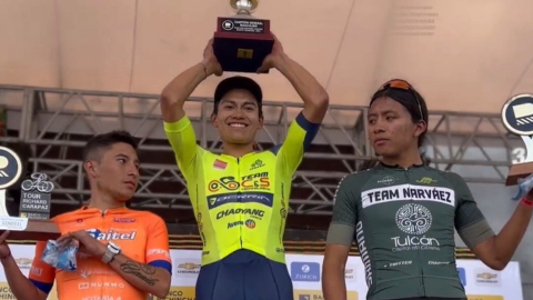 El ciclista Brayan Obando (centro) celebra en el podio el título del Tour Richard Carapaz, el 11 de junio de 2023.