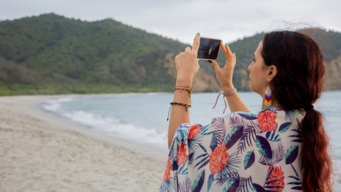 Una persona toma una foto en una playa de Ecuador, en 2023.