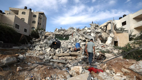 Un hombre camina sobre los escombros de la casa del palestino Bajis Nakhleh, tras ser arrasada y destruida por el ejército israelí en el campo de refugiados de Jalazone, el 28 de octubre de 2023.