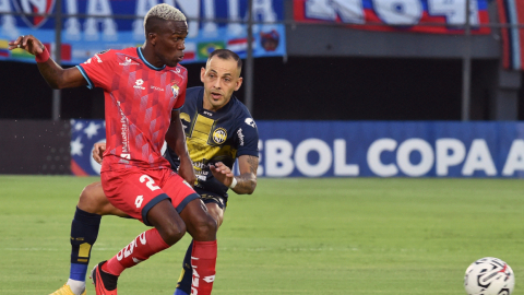 El defensor de Sportivo Trinidense Luis De La Cruz y el defensor de El Nacional Byron TorreS disputan un balón durante el partido de ida de la segunda ronda de la Copa Libertadores, el 22 de febrero 2024.