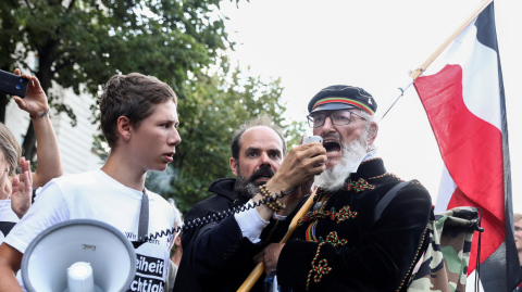 A demonstrator speaks through a megaphone during a rally against the government's restrictions following the coronavirus disease (COVID-19) outbreak, in Berlin, Germany, August 29, 2020. REUTERS/Christian Mang