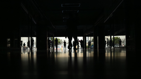 Personas caminan por el Centro comercial Ciudad Chinita con la mayoría de sus locales cerrados por falta de electricidad este 30 de agosto en Venezuela.