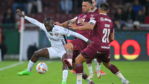 El delantero de Liga de Quito, Freddy Mina y el defensor de Lanús, Nery Domínguez  luchan por el balón durante el partido de ida de los octavos de final de la Copa Sudamericana.