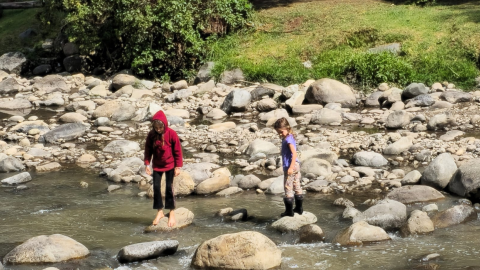 Niños cruzan el río Tomebamba, en Cuenca