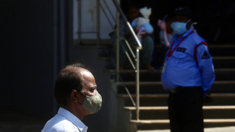 Dos hombres utilizan mascarilla en las calles de la ciudad india de Bangalore, el mismo día en que se confirmó dos casos de metapneumovirus humano (HMPV) en dicha urbe, el 6 de enero de 2025.