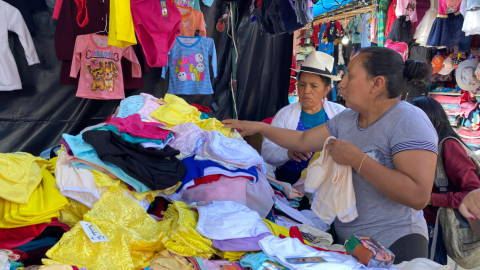 Comerciantes de ropa en el mercado El Arenal, de Cuenca, en diciembre.