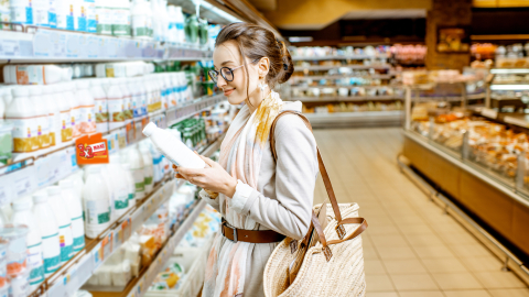 Mujer elige productos de los estantes en el supermercado.