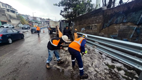 Trabajadores del Municipio durante la limpieza de una zona afectada por caída de granizo en Quito, el 22 de octubre de 2026.
