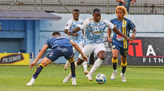 Jaime Ayoví, delantero de Emelec, intenta burlar la marca de un jugador de Delfín, este sábado 24 de agosto en el estadio Jocay.