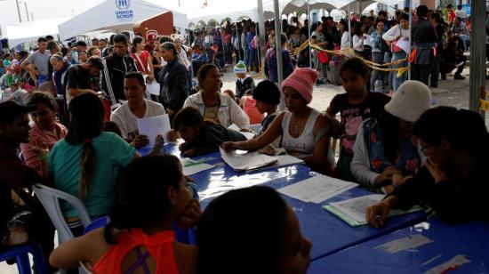 Ciudadanos venezolanos realizan trámites en el paso fronterizo de Tumbes, en la frontera de Ecuador y Perú.