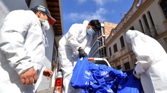 Servidores de la Prefectura y el MIES transportan bolsas con productos que serán entregados a personas de escasos recursos llamada Canasta Popular y Solidaria.