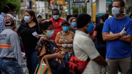 Personas hacen fila en los exteriores de una farmacia en Guayaquil, el 15 de abril de 2020.