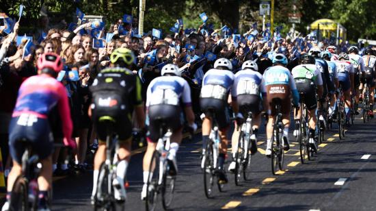 Ciclistas en el Tour de Gran Bretaña mientras el público los anima a seguir en la carrera.