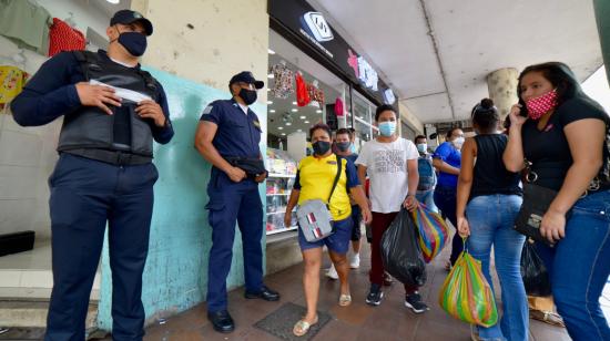 Dos policías metropolitanos de Guayaquil vigilan el sector de la Bahía, el 3 de diciembre de 2020.