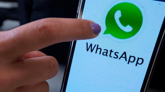 Usuario señalando el logo de WhatsApp en un teléfono inteligente.