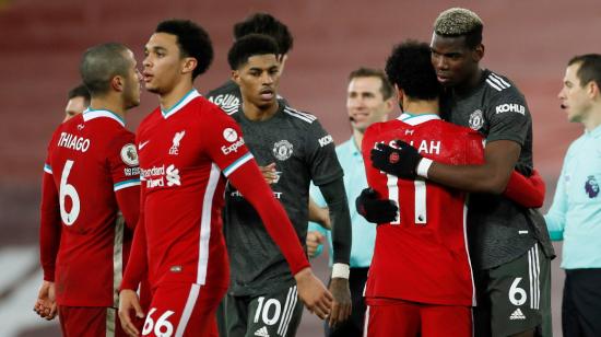 Los jugadores del Liverpool y Manchester United se saludan y abrazan  luego del partido en Anfield, este domingo 17 de enero de 2021.