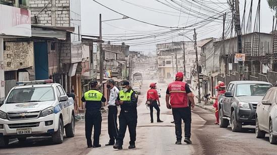 Personal de la CTE y de Bomberos colaboran en las labores de limpieza de las calles de Chunchi, tras la caída de ceniza, el 6 de marzo de 2021.