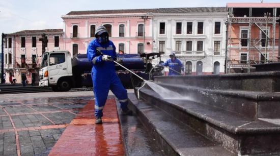 Un trabajador de Emaseo limpia la Plaza de Santo Domingo, uno de los 'puntos húmedos' de Quito, el 18 de febrero de 2021.