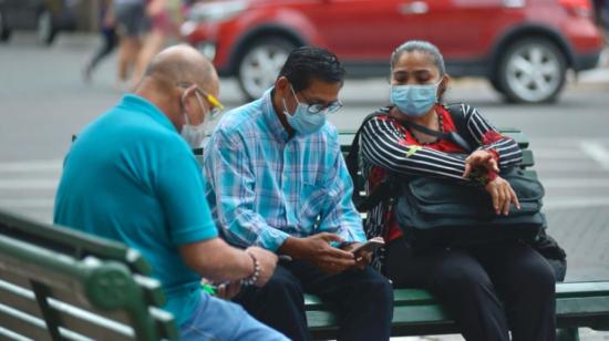 Personas revisan sus celulares en una calle de Guayaquil, el 18 de marzo de 2021.