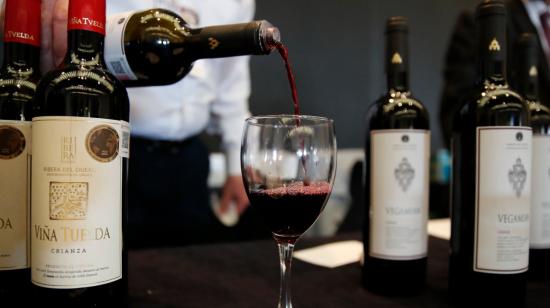 Imagen referencial de un salonero sirviendo una copa de vino en un restaurante.