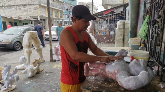 Un artesano cubre con papel y engrudo un molde en la calle 6 de Marzo y Cuenca, en  Guayaquil, el 28 de agosto del 2023.