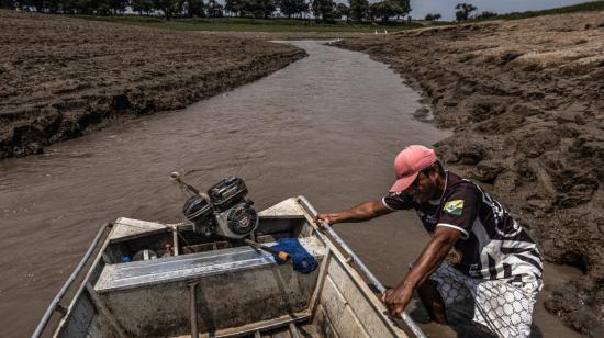 Un pescador en Brasil trata de mover su bote en un río casi seco, en la zona de Manaquiri, Amazonas, el 21 de octubre de 2023.