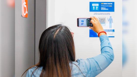 Una persona escanea un código QR en un baño en Ecuador, en 2023. 