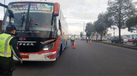 Un agente de la AMT de Quito realiza el control a un bus en la ciudad, el 1 de noviembre de 2023.