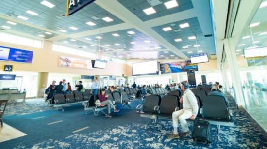 Personas esperando para abordar en el Aeropuerto Internacional Mariscal Sucre, de Quito. 