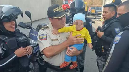 Un policía sostiene el bebé de 10 meses, secuestrado en el Guasmo Sur, en Guayaquil, el 17 de noviembre de 2023.