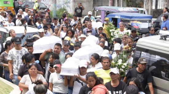 Familiares y vecinos cargan los féretros de los hermanos Jordana, Briana, Adiel y Aitana, sepultados este 14 de diciembre del 2023 en Pascuales, norte de Guayaquil. 
