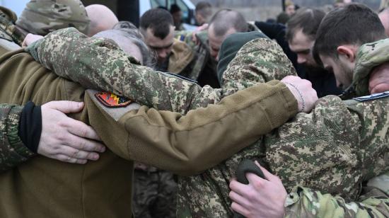 Voluntarios de la iglesia evangélica del oeste de Ucrania oran junto con militares ucranianos antes de una distribución de alimentos en las afueras de la ciudad de Sloviansk, región de Donetsk, el 13 de febrero de 2024, en medio de la invasión rusa de Ucrania. 