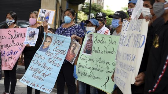 Familiares que buscan el cuerpo de sus familiares que se han perdido o se han identificado erróneamente durante el brote de la enfermedad por coronavirus (COVID-19), sostienen carteles de protesta. Guayaquil, Ecuador. 20 de mayo de 2020.