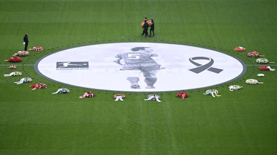 Los miembros del personal colocan coronas de flores junto a una fotografía de la fallecida leyenda del fútbol alemán Franz Beckenbauer antes de una ceremonia de despedida organizada por su histórico club Bayern Munich en el estadio Allianz Arena en Munich, sur de Alemania, el 19 de enero de 2024.