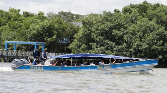 Migrantes se trasladan en lancha, el 8 de julio de 2024, en Turbo (Colombia) hacia la selva del Darién.