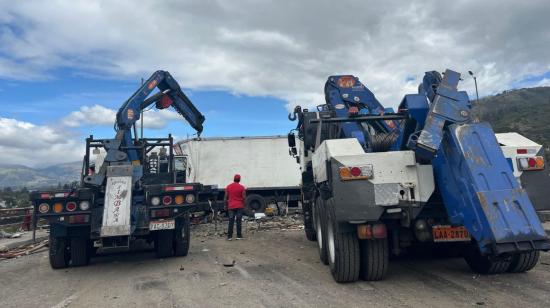 Dos grúas retiran a un camión accidentado en un siniestro múltiple en la Ruta Viva el 25 de julio de 2024 en Quito.