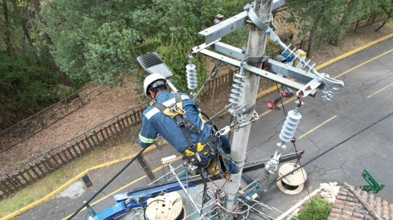 Un trabajador de la Empresa Eléctrica Quito realiza labores de mantenimiento en el norte de Quito, el 9 de agosto de 2024. Imagen referencial.