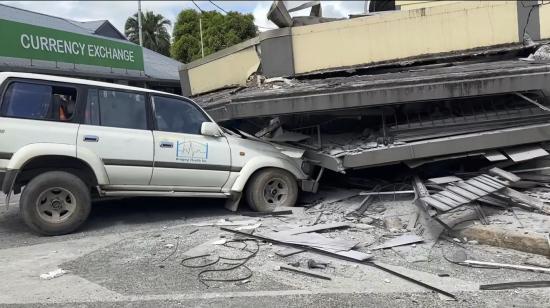 Un auto queda atrapado por el colapso de un edificio en Port Vila, la capital de Vanuatu, después del impacto de un terremoto de magnitud 7,3 el 17 de diciembre de 2024.