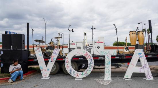 Un gran cartel con la palabra 'Vota' descansa afuera de un mitin político en Texas, el 25 de octubre de 2026.